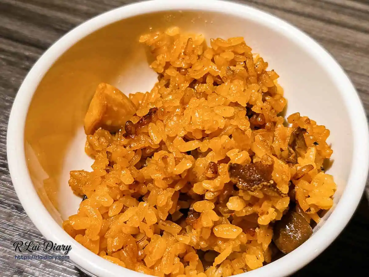 盛裝在碗中的麻油雞飯，米粒油亮，色澤誘人