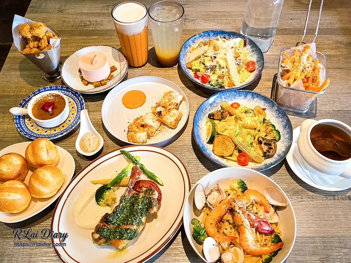 羽樂歐陸創意料理滿桌豐盛餐點大合照，包含排餐、義大利麵與各式開胃小點，台北小巨蛋美食與松山區聚餐餐廳推薦