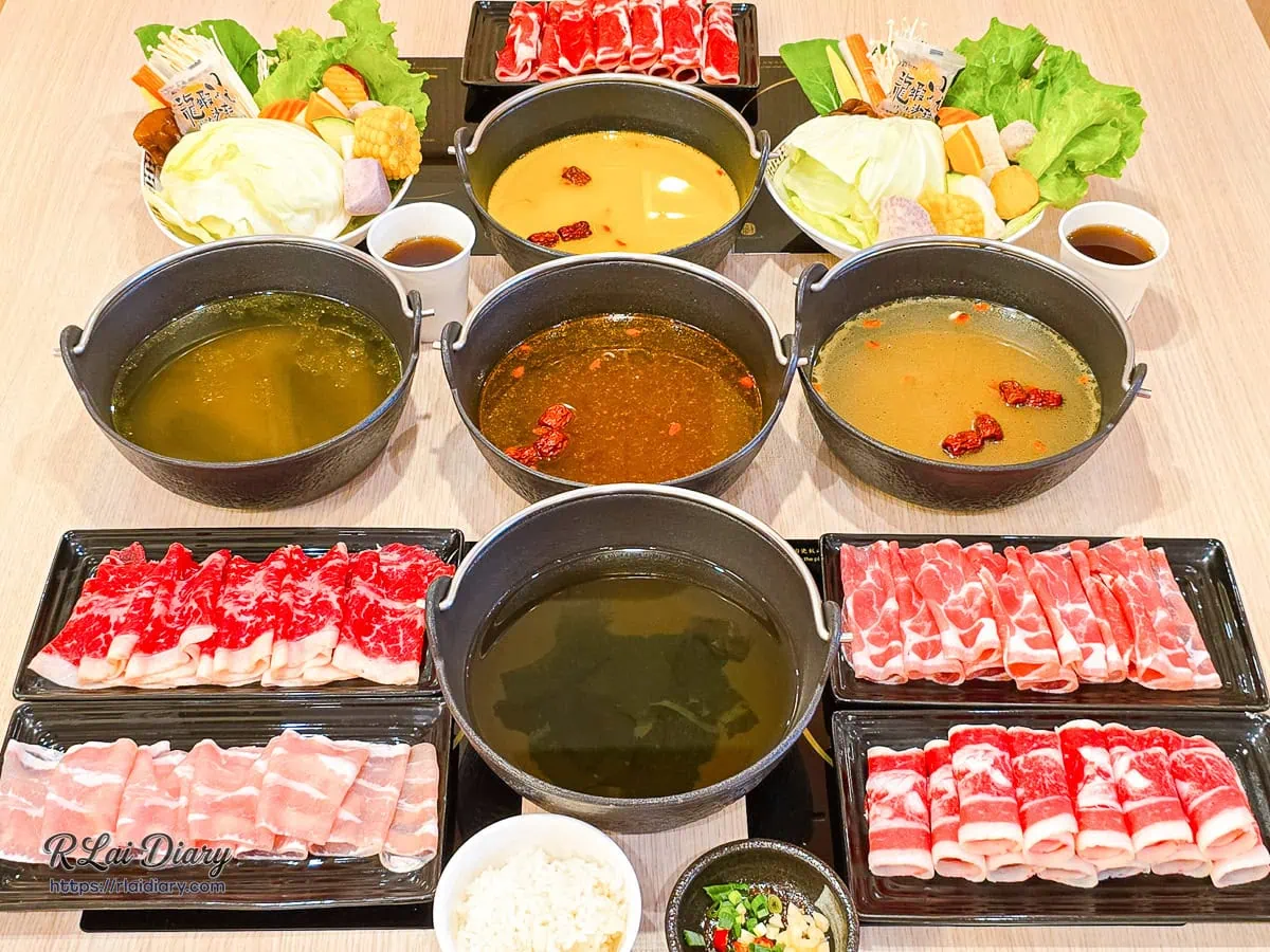 台中潭子初暖鍋物豐富澎湃的餐點合照，包含精緻湯底、肉品盤與繽紛綜合菜盤
