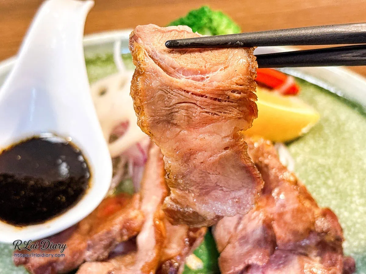 筷子夾起豐潤多汁的伊比利豬肉片搭配松露醬